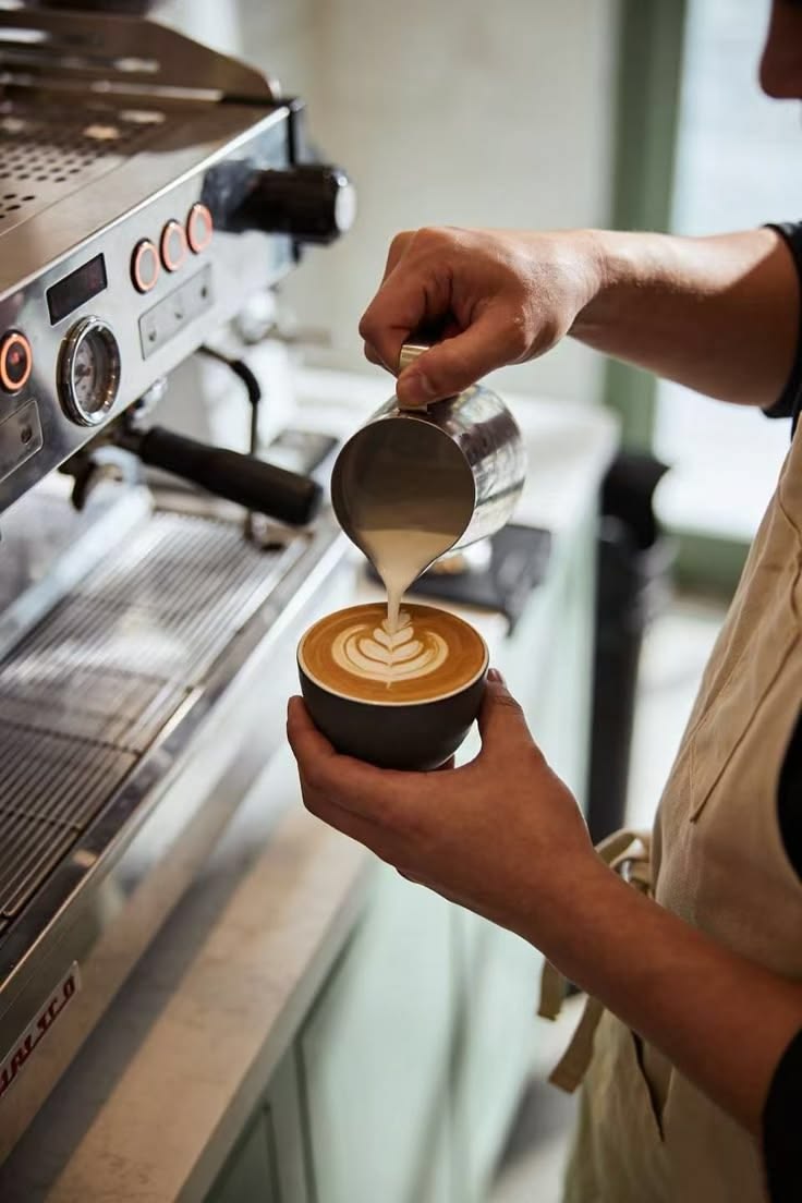 A Bean Theory barista finishing a latte
