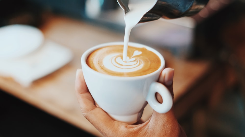 Latte art poured into a flat white